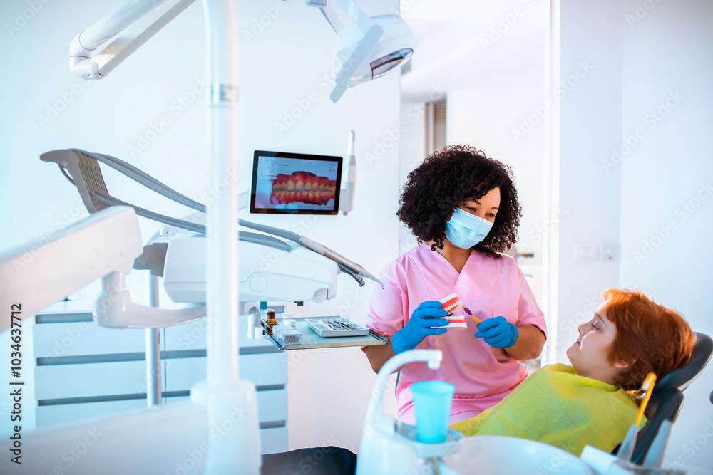 Young boy in a dental office having a female dentist work on his teeth