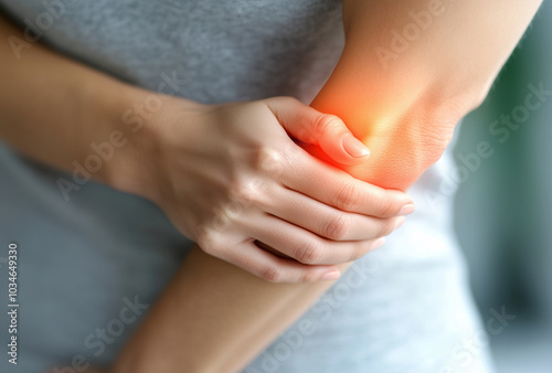 a person holding elbow with pain 