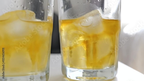 Whiskey and natural ice on white table