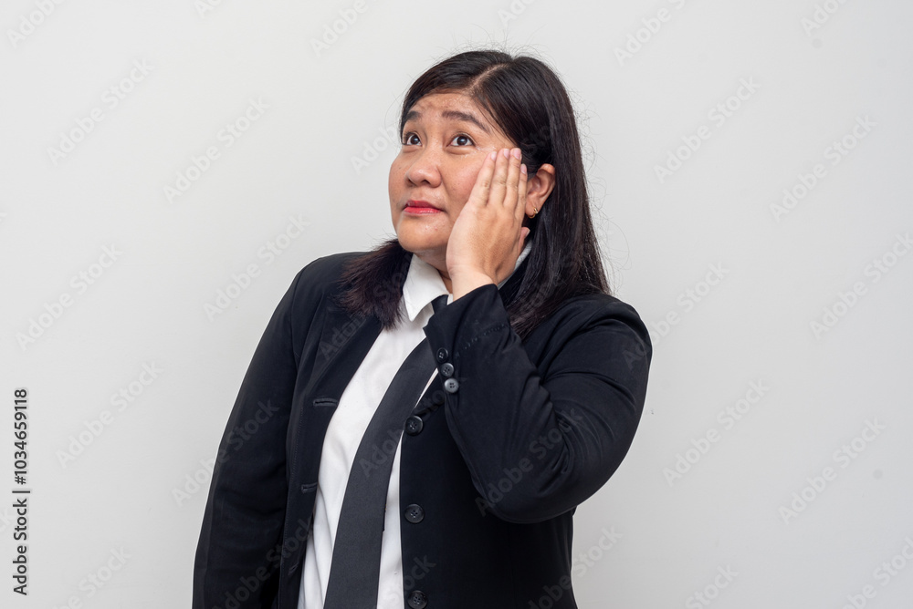 The woman appears pensive, with one hand resting on her cheek, as if lost in thought. Her body language and expression convey a sense of reflection or problem-solving. The woman appears pensive, with one hand resting on her cheek, as if lost in thought. Her body language and expression convey a sense of reflection or problem-solving.
