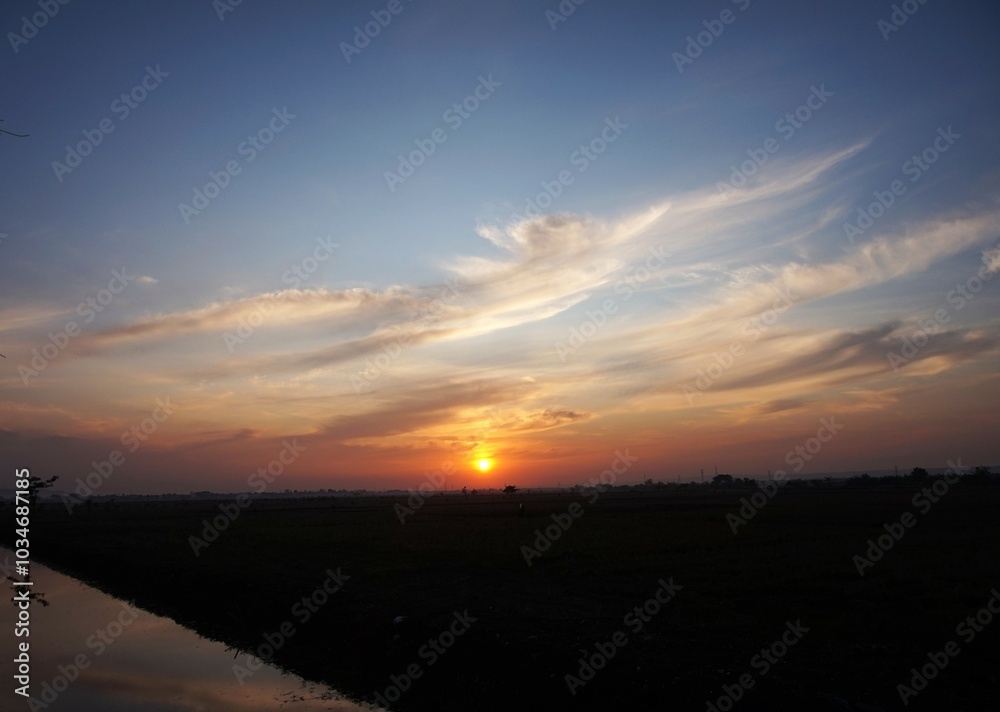 Fototapeta premium photo of the sky in a bright afternoon, and the sun looks yellow about to set and beautiful white clouds