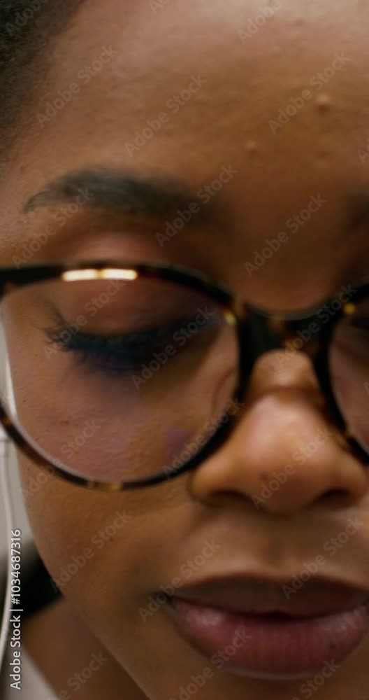 A woman in formal clothes and with earphones is riding in a subway car. Close-up of her focused face A woman in formal clothes and with earphones is riding in a subway car. Close-up of her focused face