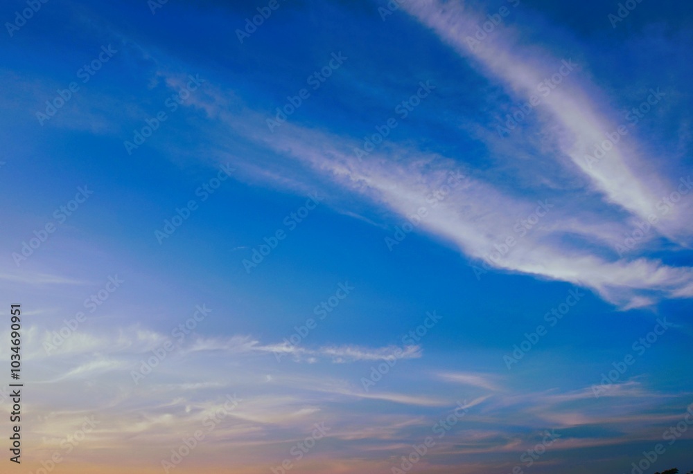 Fototapeta premium photo of a clear sky during the day, blue and there are uniquely shaped white clouds