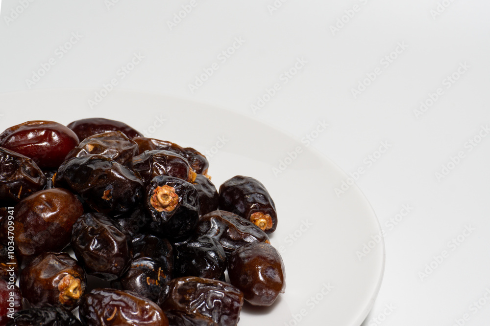 Dried dates on white background. Premium quality date fruit isolated on a plate. Date fruit with white background. Dried dates on white background. Premium quality date fruit isolated on a plate. Date fruit with white background.