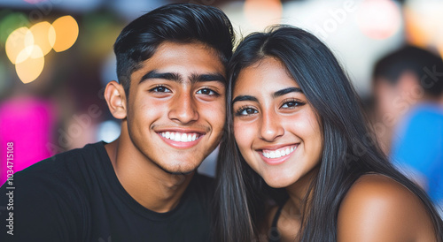 A beautiful young couple smiling at the camera while sitting at a large table adorned with a turkey for their Christmas dinner, capturing a cozy home atmosphere. This image showcases warmth and togeth photo