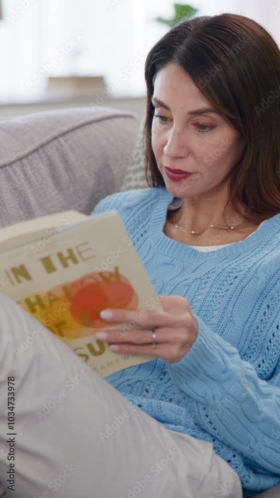 Mature woman, peace and reading book on sofa for fiction literature, story and hobby in living room. Home, comfortable and female person with novel on weekend for fantasy, knowledge and learning Mature woman, peace and reading book on sofa for fiction literature, story and hobby in living room. Home, comfortable and female person with novel on weekend for fantasy, knowledge and learning