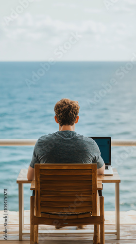 Person working on laptop by the ocean