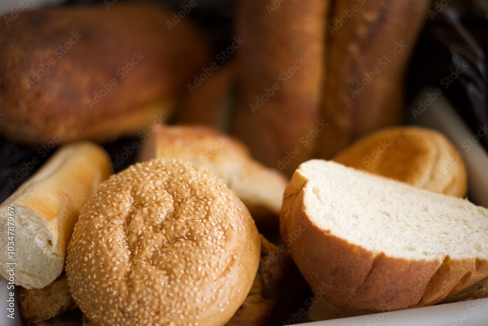 Loaves of Fresh baked bread in a breadbasket, focused on some sesame seeds. Loaves of Fresh baked bread in a breadbasket, focused on some sesame seeds.