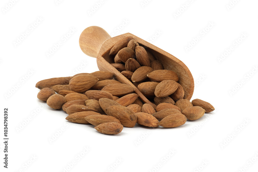Wooden scoop overflowing with almonds isolated on white background Wooden scoop overflowing with almonds isolated on white background