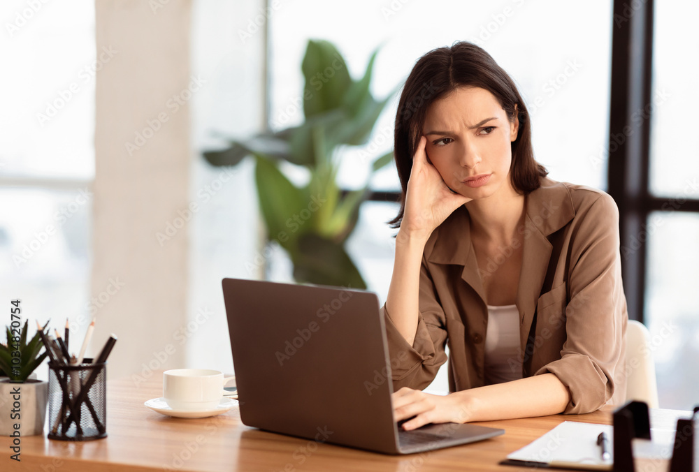 What To Do. Puzzled confused woman thinking hard concerned about problem solution looking aside, using laptop, copyspace What To Do. Puzzled confused woman thinking hard concerned about problem solution looking aside, using laptop, copyspace