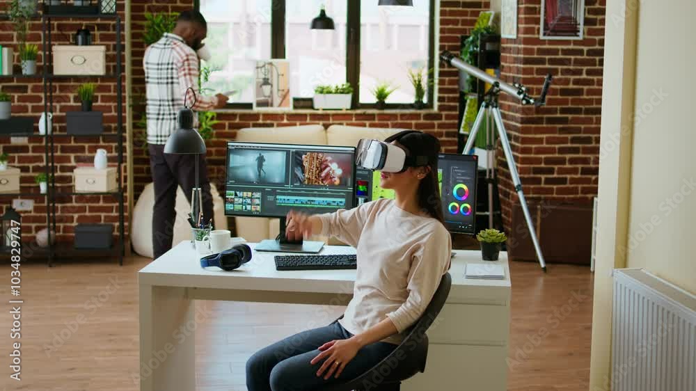 Asian modern editor using virtual reality glasses and mixing video clips, using interactive gadget vr headset to edit and do color grading for a montage. Video editing software. Camera A.