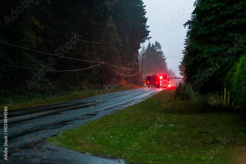 Fire truck responds to a fallen tree across the road in rural Vancouver Island photo