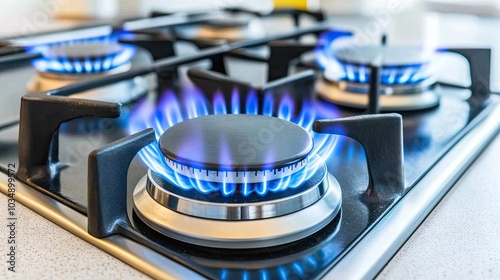 Close-up of a gas burner in a domestic kitchen with blue flames burning brightly, symbolizing propane energy and heating issues.