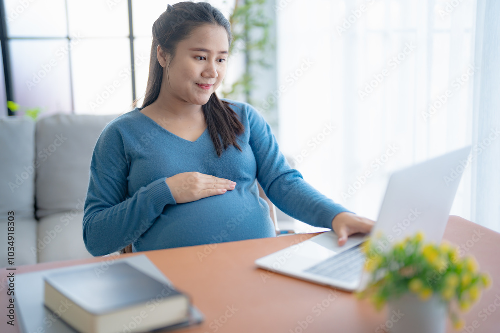 Pregnant asian woman using laptop at home pregnant businesswoman typing on laptop working on remote project in home office pregnancy concept Pregnant asian woman using laptop at home pregnant businesswoman typing on laptop working on remote project in home office pregnancy concept