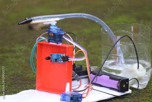 Working prototype of a fire detection and water spraying robot made with microcontroller. Fire fighting mini robot made for engineering projects photo