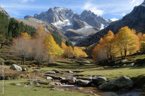 Prado verde con un riachuelo que baja de alta montaña nevada de fondo de la imagen. Paisaje montañoso. Aire puro en alta montaña. photo