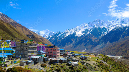 A vibrant view of Kyanjin Gompa, a small village in Nepal's Langtang Valley, with colorful buildings set against the stunning backdrop of snow-capped Himalayan peaks. A popular spot for trekkers. photo