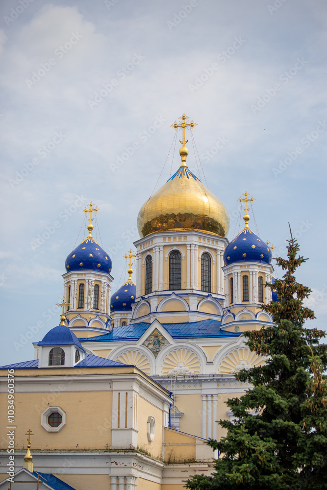 The blue and white church has a gold dome and crosses on top The blue and white church has a gold dome and crosses on top