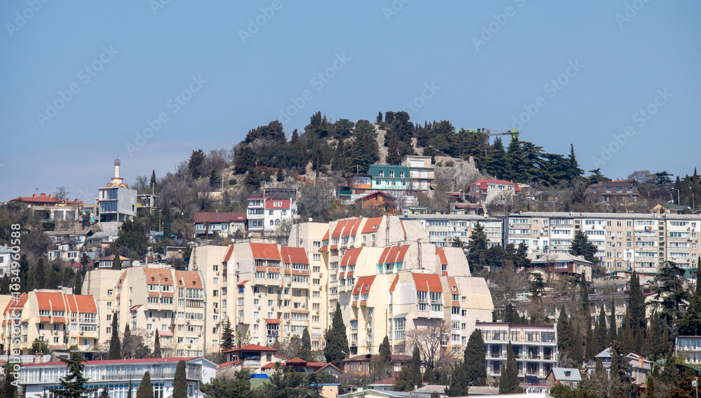 A city with many buildings and a hill in the background A city with many buildings and a hill in the background