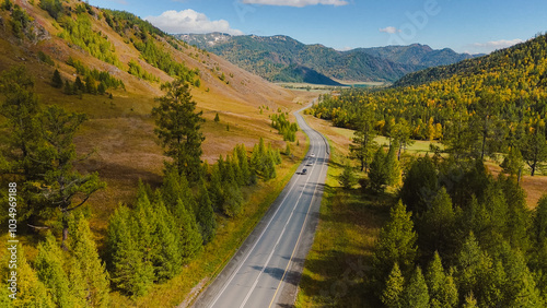 the car is driving along the Chuisky highway in Altai in autumn