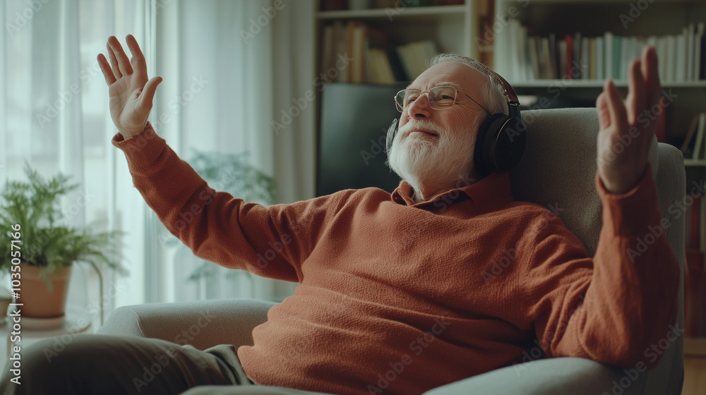 Elderly man enjoying music at home, sitting in an armchair and wearing headphones Elderly man enjoying music at home, sitting in an armchair and wearing headphones