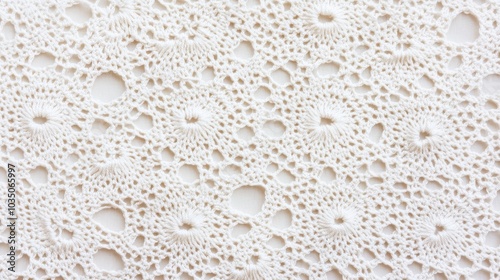 Delicate handmade crochet fabric with intricate pattern and texture design in soft white hues