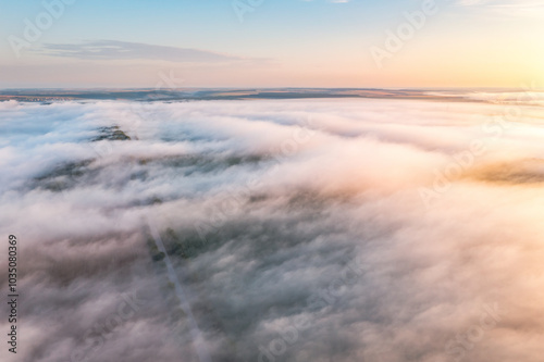 From a bird's eye view, fog is creeping over the valley.