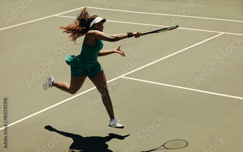 Powerful forehand hit by professional woman tennis player on court photo