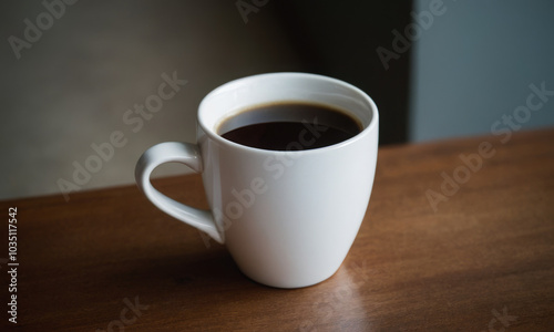 White Ceramic Mug with Black Coffee on Wooden Surface: Clean and Simple