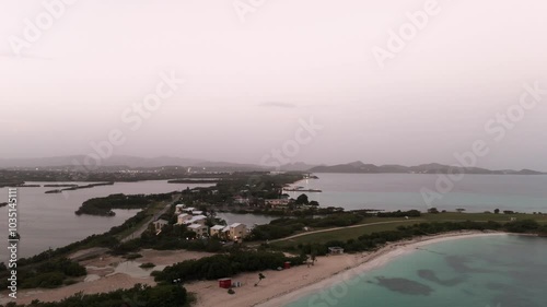 Scenic Landscape Of Dickenson Bay On A Misty Atmosphere In Northwestern Coast Of Antigua. aerial, wide shot photo