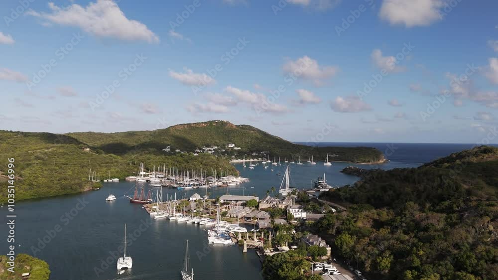 English Harbor with yachts and boats docked in scenic Nelson’s Dockyard Antigua under a blue sky English Harbor with yachts and boats docked in scenic Nelson’s Dockyard Antigua under a blue sky