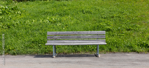 Wooden bench outside on the side of a Swiss road up a mountain pass.