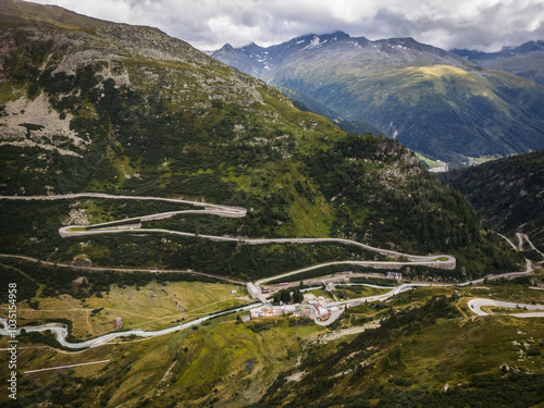 Aerial view of winding road through majestic mountains and serene valley, Oberwald, Switzerland. photo