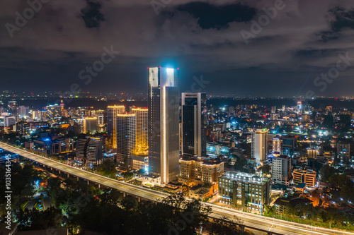 Aerial view of vibrant cityscape with illuminated buildings and bustling traffic, Westlands, Nairobi, Kenya.