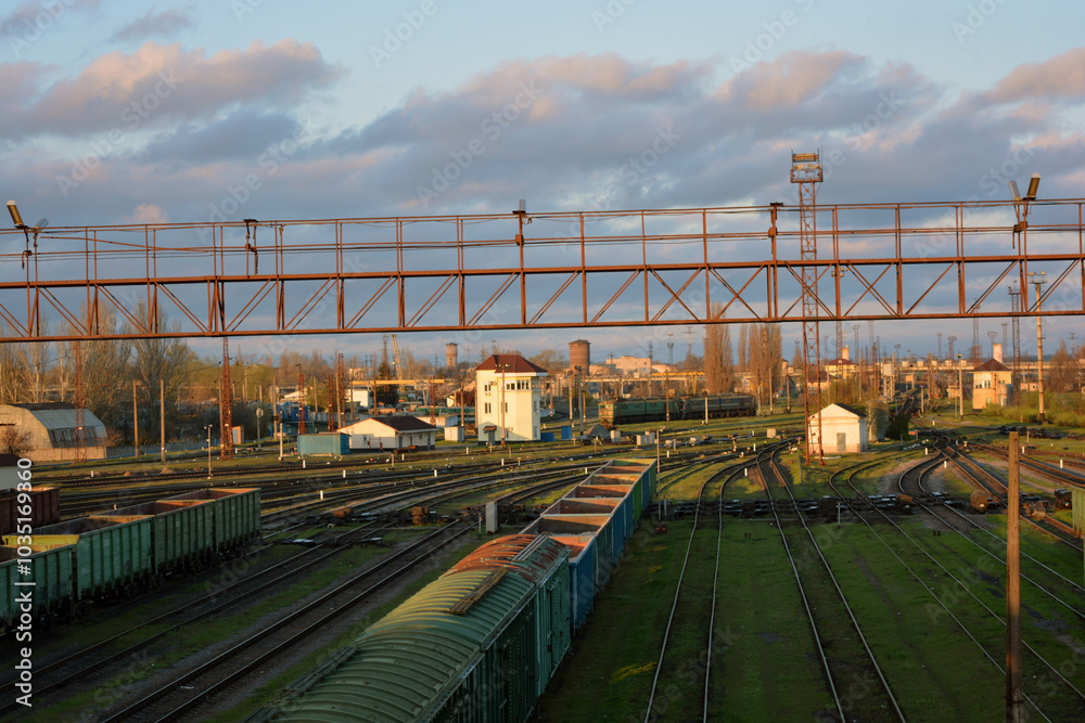 Beautiful and vivid photos of green nature with railway lines, knot with metal rails, railway cars made of dark metal against the blue sky. Beautiful and vivid photos of green nature with railway lines, knot with metal rails, railway cars made of dark metal against the blue sky.