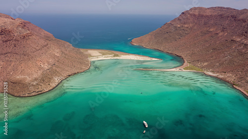 Aerial view of breathtaking turquoise beach and clear water cove with rocky cliffs, Isla Espiritu Santo, Baja California Sur, Mexico.