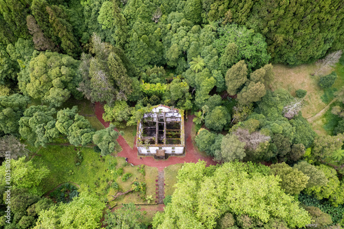 Aerial view of lush forest and overgrown ruins in a tranquil park, Furnas, Portugal. photo