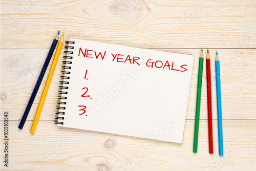 new year goals concept, social media post template, minimalistic white wooden table with colorful pencils background