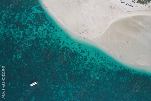 Aerial view of Bills Bay with beach goers and a reef boat, Coral Bay, Australia. photo