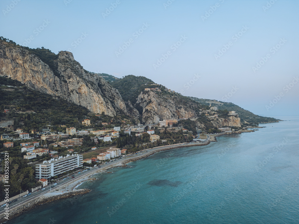 Aerial view of picturesque coastline with serene sea and beautiful town nestled in mountains, Menton, Garavan, France. Aerial view of picturesque coastline with serene sea and beautiful town nestled in mountains, Menton, Garavan, France.