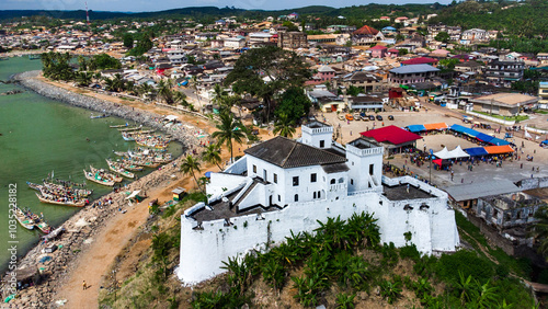 Aerial view of Fort Santo Antonio and the coastal town with fishing boats and palm trees, Axim, Ghana. photo