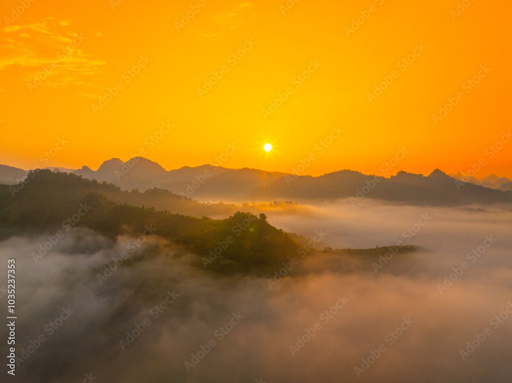Orange sky and sea of clouds before sunrise. A peaceful, refreshing feeling. View of the hills surrounding Ba Quang, Ha Lang district, Cao Bang province, Vietnam Orange sky and sea of clouds before sunrise. A peaceful, refreshing feeling. View of the hills surrounding Ba Quang, Ha Lang district, Cao Bang province, Vietnam