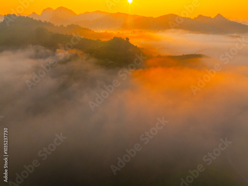 Orange sky and sea of clouds before sunrise. A peaceful, refreshing feeling. View of the hills surrounding Ba Quang, Ha Lang district, Cao Bang province, Vietnam