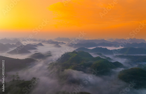 Orange sky and sea of clouds before sunrise. A peaceful, refreshing feeling. View of the hills surrounding Ba Quang, Ha Lang district, Cao Bang province, Vietnam