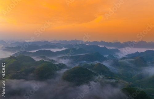 Orange sky and sea of clouds before sunrise. A peaceful, refreshing feeling. View of the hills surrounding Ba Quang, Ha Lang district, Cao Bang province, Vietnam