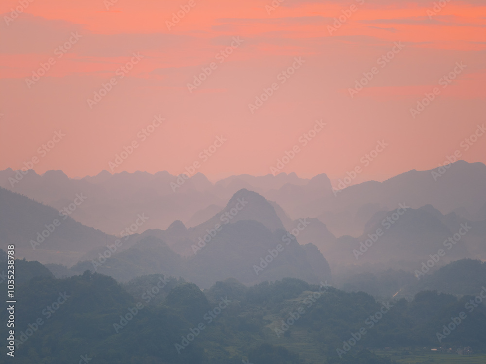 Orange sky and sea of clouds before sunrise. A peaceful, refreshing feeling. View of the hills surrounding Ba Quang, Ha Lang district, Cao Bang province, Vietnam Orange sky and sea of clouds before sunrise. A peaceful, refreshing feeling. View of the hills surrounding Ba Quang, Ha Lang district, Cao Bang province, Vietnam