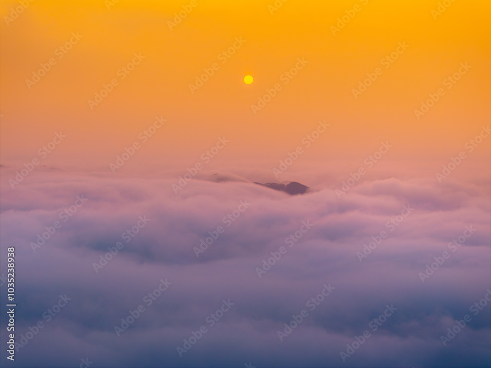 Orange sky and sea of clouds before sunrise. A peaceful, refreshing feeling. View of the hills surrounding Ba Quang, Ha Lang district, Cao Bang province, Vietnam