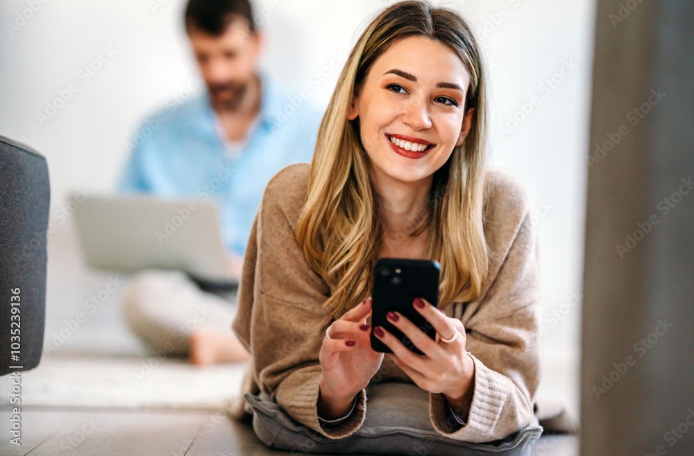 Smiling young female using mobile phone app playing game, shopping online, ordering delivery Smiling young female using mobile phone app playing game, shopping online, ordering delivery