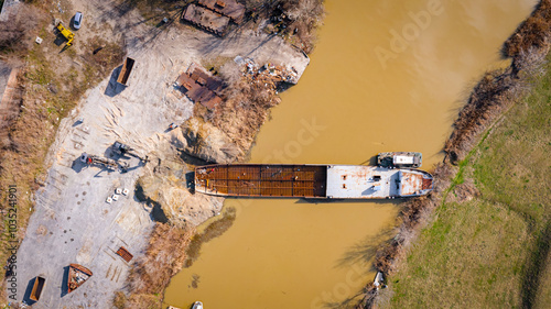 Aerial view on excavator, tow truck and tugboat as they move part of vessel photo