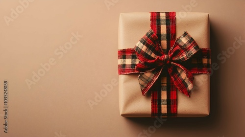 Cozy Present Wrapped in Plaid Bow on Beige Background